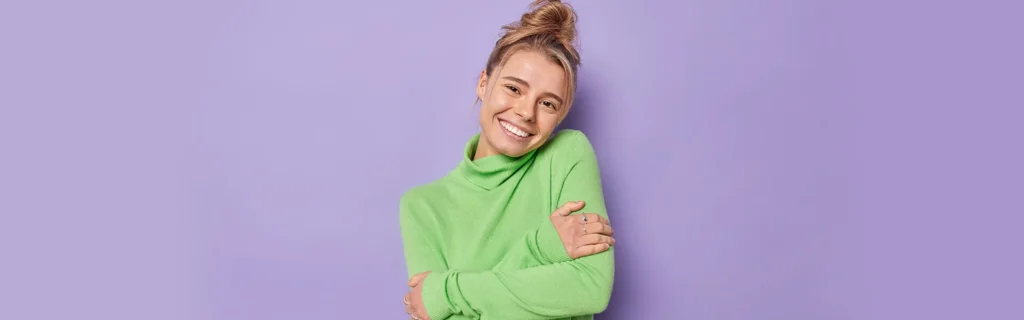 a happy women in green shirt and purple background after treatment in sd clicinc