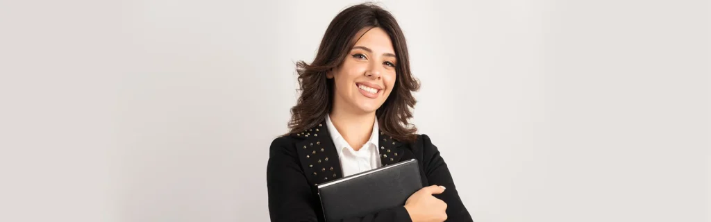 lady in black dress smiling and holding file in her hands